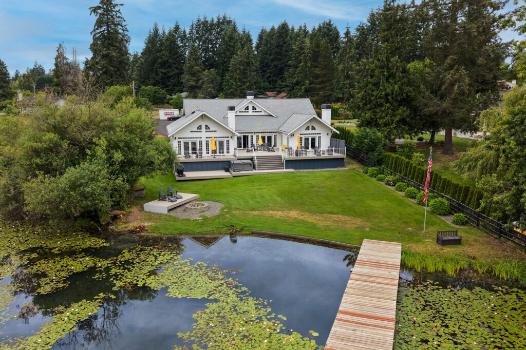Aerial view of Lake Meridian waterfront home for sale in Kent WA with lawn and 100-foot dock