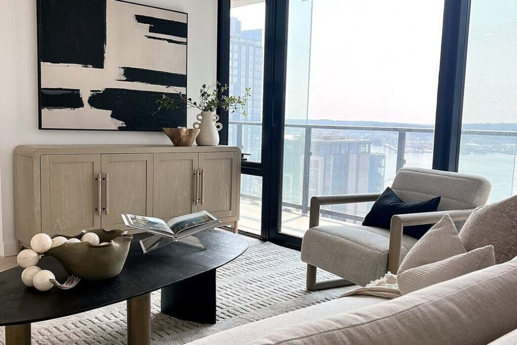 Furnished living room at First Light Residence 2911 with floor-to-ceiling corner windows over Seattle